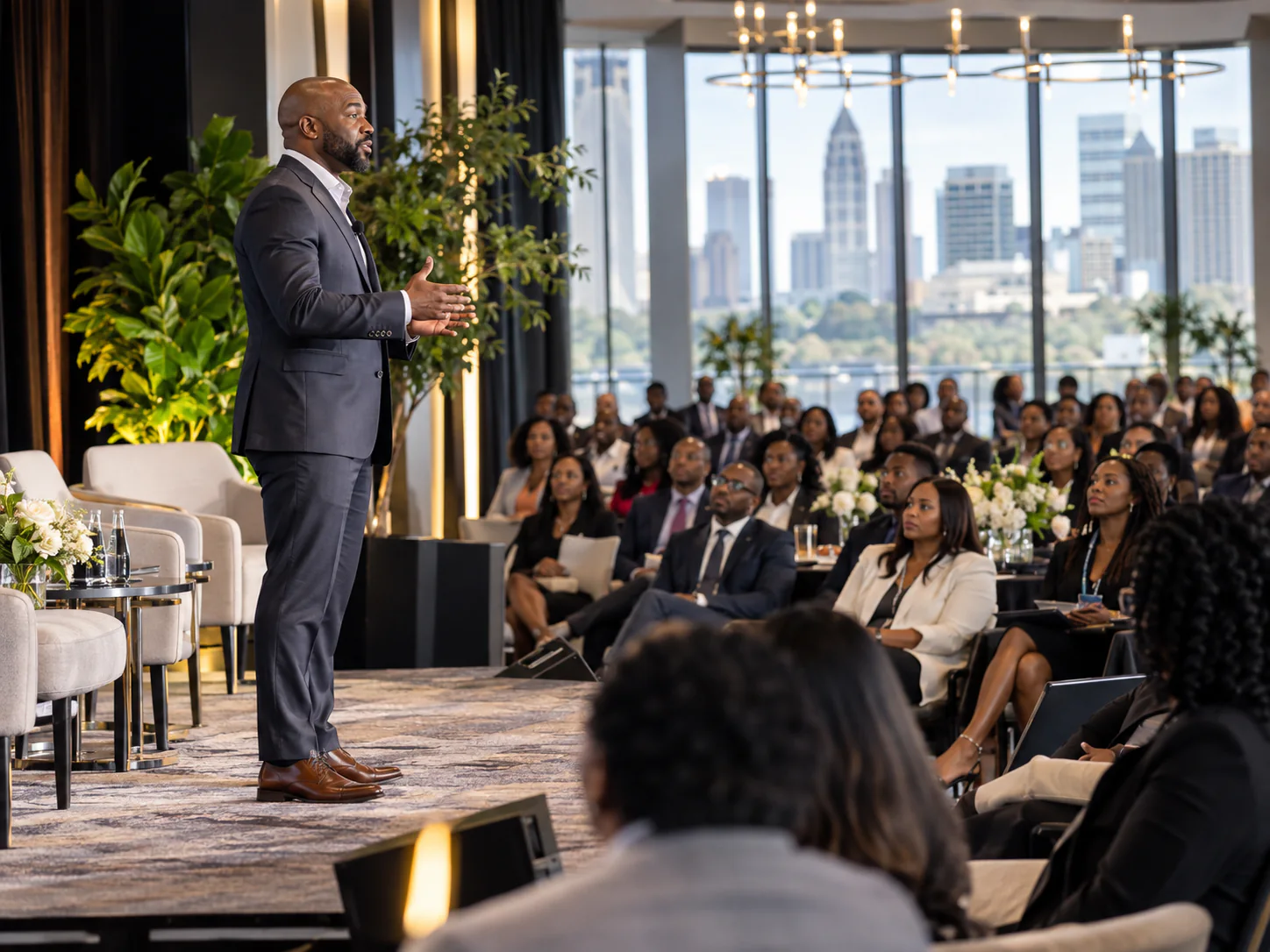 Speaker addressing a full room of attendees at an Atlanta corporate event